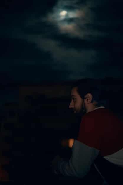 A cinematic shot of a popular character from a returning Netflix series, with a blurred background showing a dramatic scene setting.