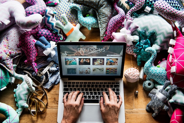 A laptop screen displaying a curated list of indie films and documentaries on a streaming platform, with a focus on the diverse genres and unique storytelling styles available. The setting is a cozy home office with bookshelves in the background.