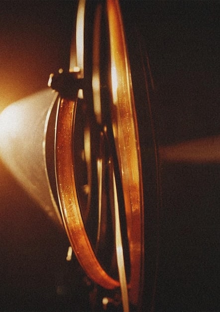 A close-up shot of a film reel with the light shining on it. The film reel is slightly scratched and worn, implying the timelessness of cinema and its capacity to create debate.