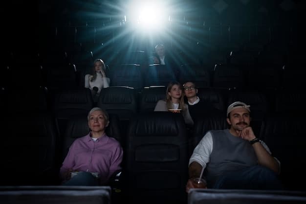 Wide shot of a packed movie theater, faces illuminated by the light of the screen. Some viewers are laughing, while others are intently focused on the movie, showcasing the diverse reactions to the film being screened.