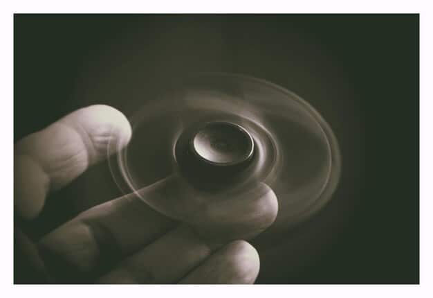 A close-up shot of the spinning top from Inception, slightly blurred to emphasize the uncertainty of whether it will fall or continue spinning, the definitive answer about Cobb's reality.