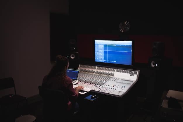 A dimly lit recording studio with a large mixing console and various soundproofing elements, indicating a professional setup for creating and manipulating sound for film.
