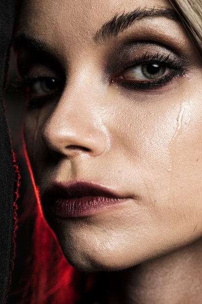 A close-up shot of Cassie Howard (Sydney Sweeney) crying with heavy makeup smeared on her face, reflecting her emotional turmoil and desperation.