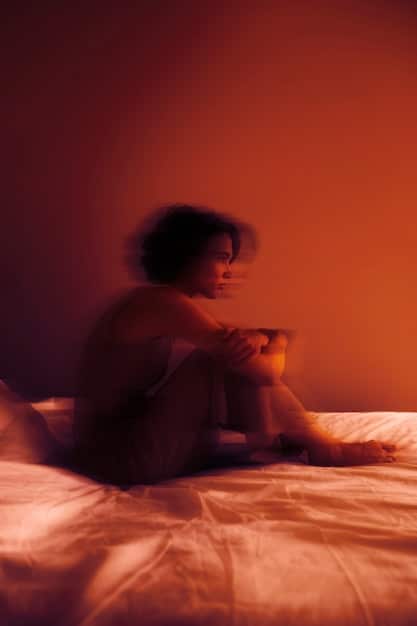 Rue, played by Zendaya, sitting alone in her bedroom surrounded by pills, with a despondent expression. The lighting is dim and somber, emphasizing her isolation and struggle with addiction.