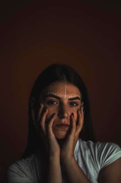 A close-up shot of Zendaya as Rue in Euphoria, looking distressed and emotional, with tears in her eyes. The lighting is dim, emphasizing her vulnerability and internal struggle.