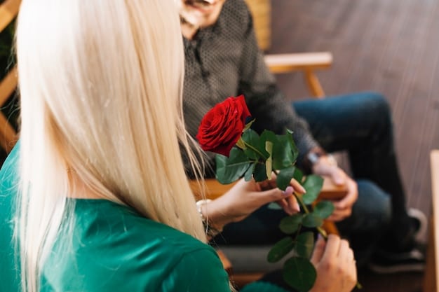 A photo of Joey Graziadei handing out a rose during the first rose ceremony, with several women looking on expectantly.