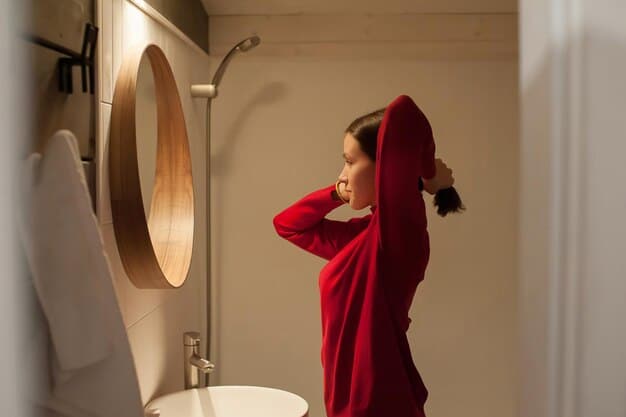 A medium shot of Cassie (Sydney Sweeney) in a bathroom, frantically getting ready. The lighting is harsh and unflattering, emphasizing her anxiety and desperation. The mirror reflects her distorted expression.