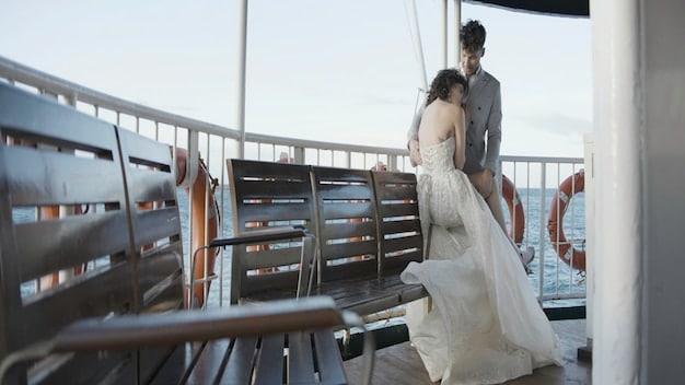 Wide shot of the opulent yacht where Connor's wedding is being held, contrasting the luxurious setting with the somber mood of the characters gathered on deck. Include details like champagne glasses, flowers, and the vast ocean backdrop.