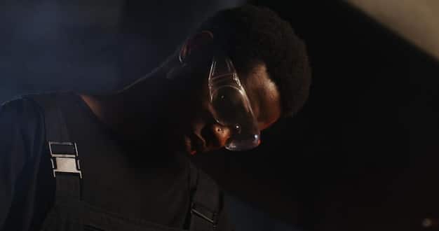 Detective Griggs (played by Ntare Guma Mbaho Mwine) looking intently at a crime scene photo, suggesting a pivotal moment in one of Haller's cases. The image should highlight the tension and investigative aspects of the plot.