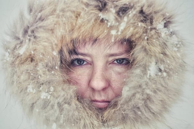 A close-up shot of Dot Lyon's determined face, covered in snow. Her eyes are focused and her expression is fierce.