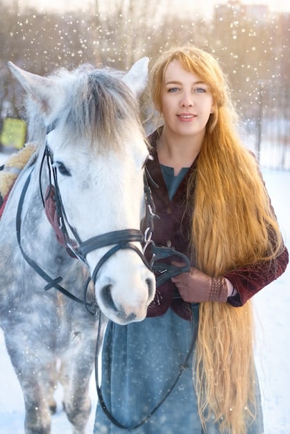 A close-up of Elsa Dutton riding on horseback, her face determined and full of youthful exuberance despite the harsh conditions around her. The backdrop is a vast, open prairie.