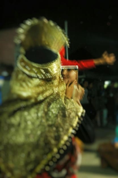 A behind-the-scenes photo of the House of the Dragon set, showing the intricate costumes and set design, highlighting the scale and attention to detail of the production.