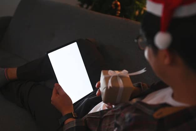 A person holding a tablet in a darkened movie theater, illuminated by the screen showing trailers of upcoming holiday movies, emphasizing the modern way of consuming movie information.