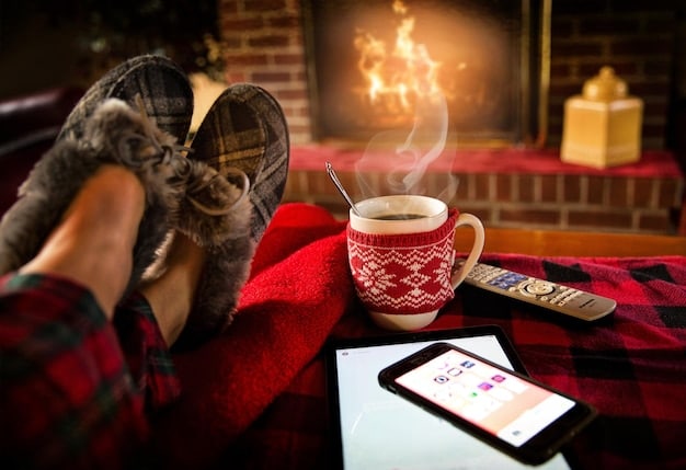 A person sitting on a couch, wrapped in a cozy blanket, holding a mug of hot chocolate, and using a tablet to browse holiday movies on a streaming platform.