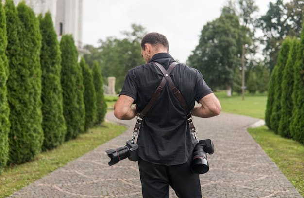A director pointing someone's shoulder with a camera during filming