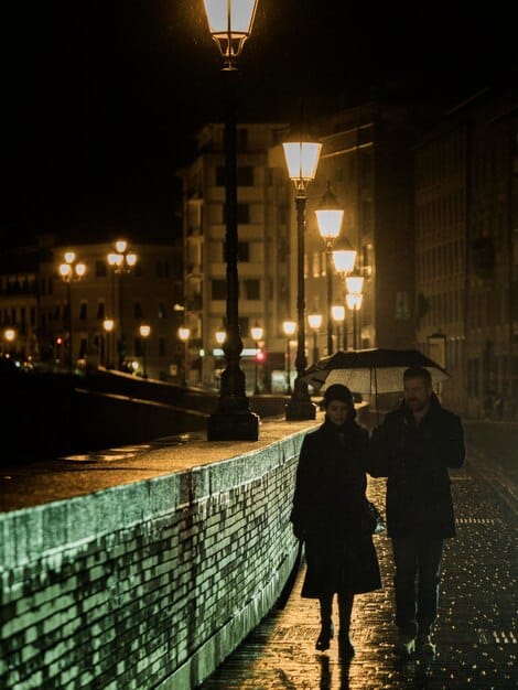 Dark and moody scene from a German crime thriller, featuring a detective standing in the rain-soaked streets of Berlin. The scene captures the gritty realism and suspenseful atmosphere of the film.
