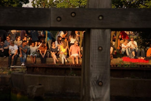 A crowd of people watching a film at an outdoor screening during a film festival. The image shows the communal and celebratory atmosphere of these events.