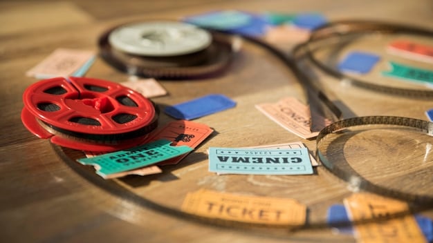 A close-up shot of a film festival program book, with several highlighted titles indicating the most anticipated movies. The background features blurred images of attendees and event posters.