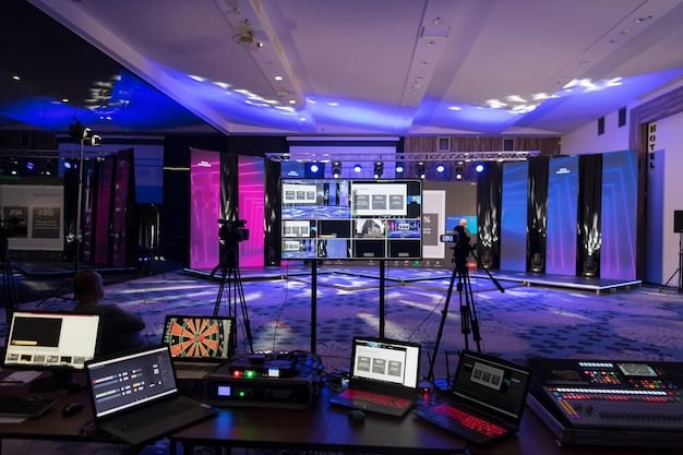 A panoramic shot of a TV show set, showing the various components of production, highlighting the complexity behind bringing a series to life. Camera crew, actors in makeup, and the director can be seen in the image.