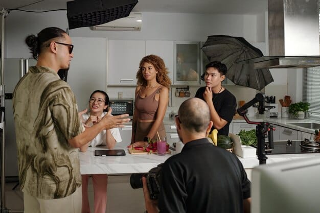A group of contestants on a cooking competition reality show, looking stressed and determined in a professional kitchen setting.