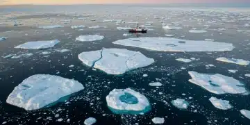 Rapidly melting Arctic icecap with open water, signifying climate crisis urgency.
