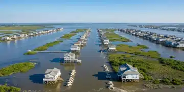 Resilient U.S. coastal community with elevated homes and natural defenses against rising sea levels.