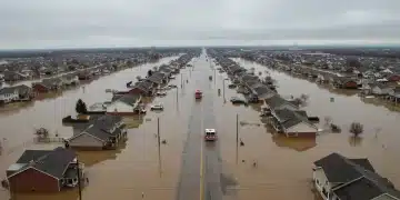 Flooded suburban street in the U.S. due to extreme weather, highlighting urgent global warming policies.